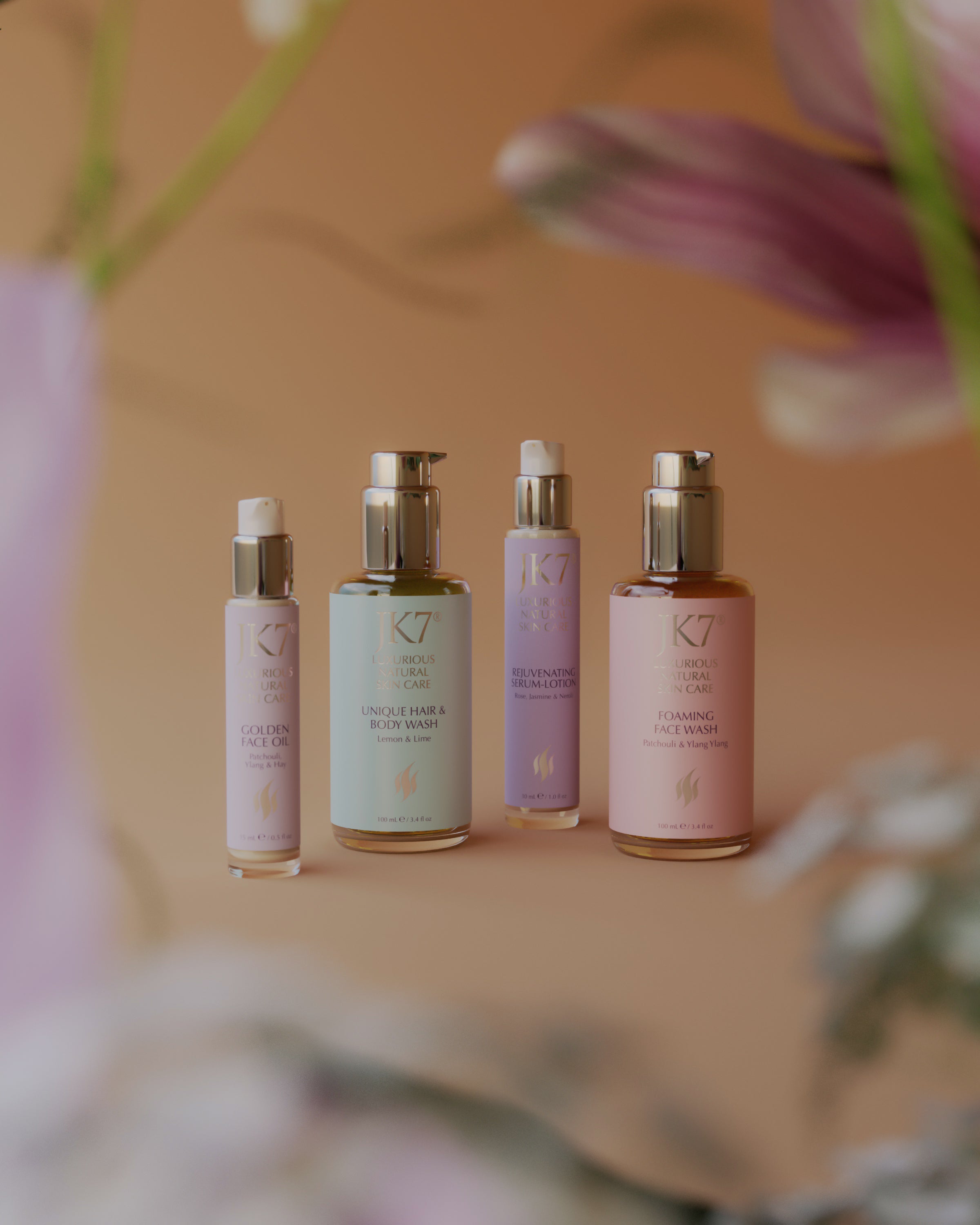 JK7 skincare products arranged with soft floral accents, highlighting gentle formulas that support long-term skin longevity