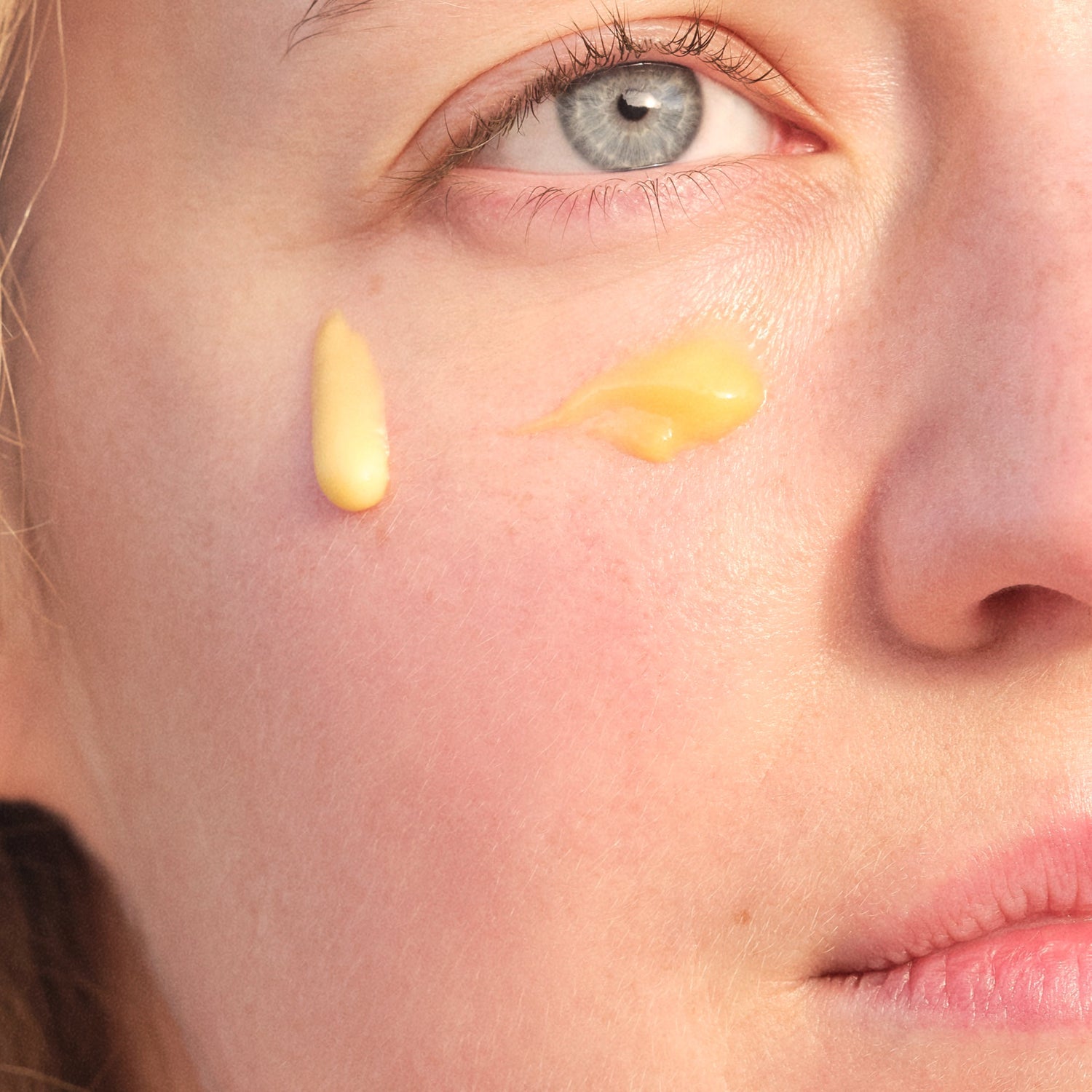 Closed up women face using cream with rich texture
