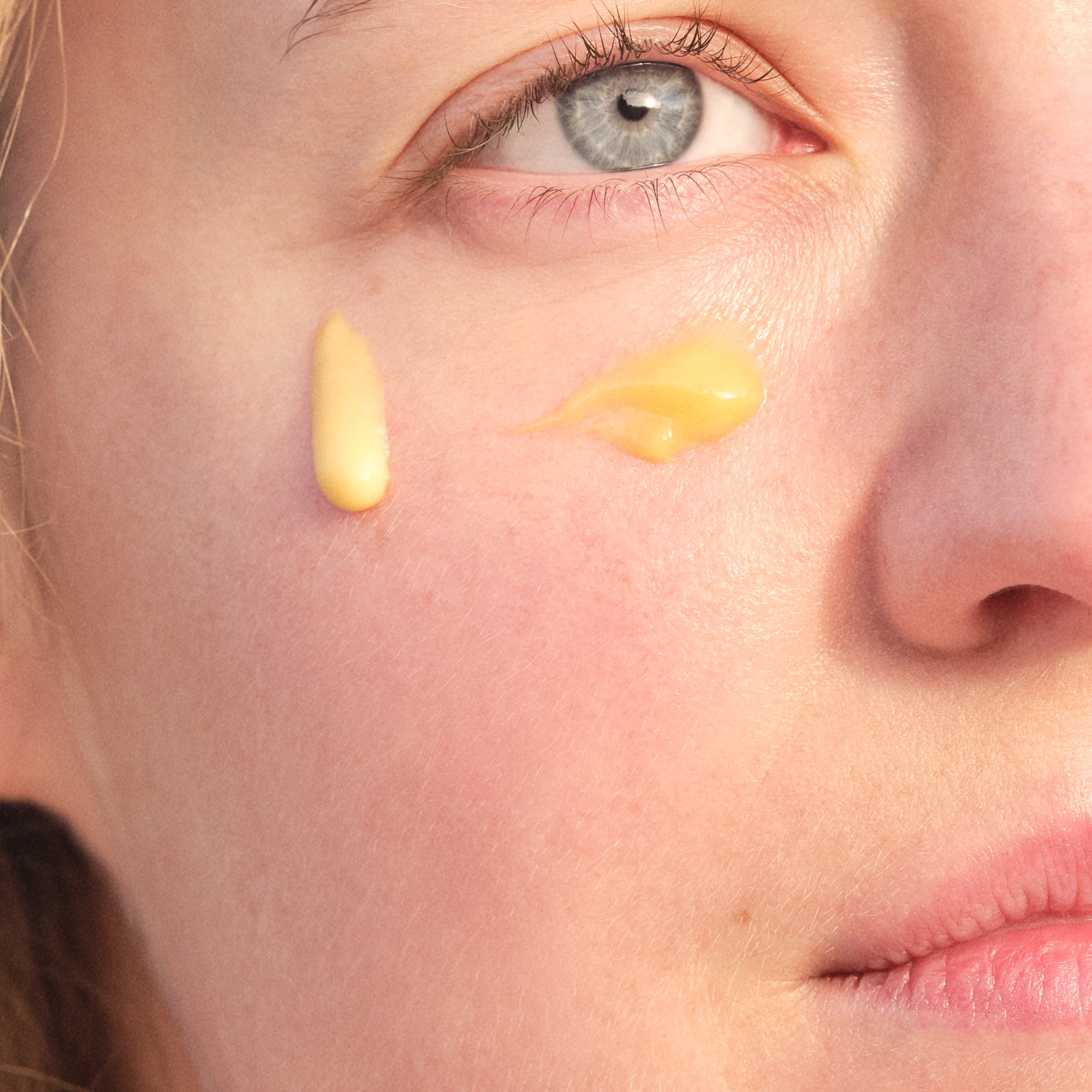 Closed up women face using cream with rich texture