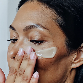 Woman applying jk7 skincare cream to her face